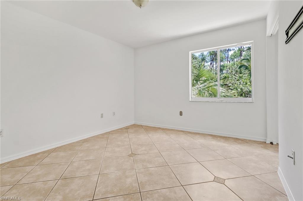 4540 Pine Ridge Road Naples, FL 34119 - Photo 21 of 30 a view of an empty room with a window