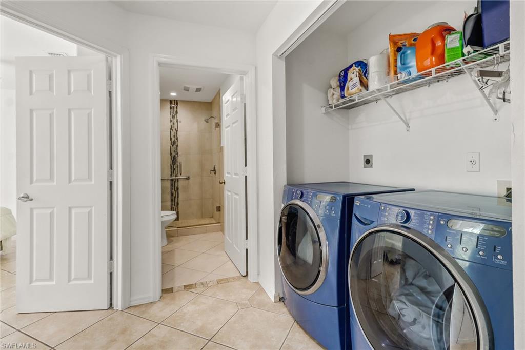 4540 Pine Ridge Road Naples, FL 34119 - Photo 24 of 30 a view of a hallway with washer and dryer