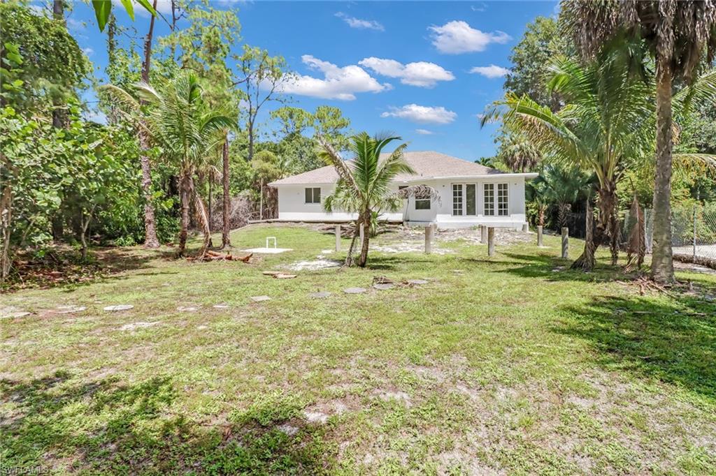 4540 Pine Ridge Road Naples, FL 34119 - Photo 27 of 30 a house with huge tree in front of it