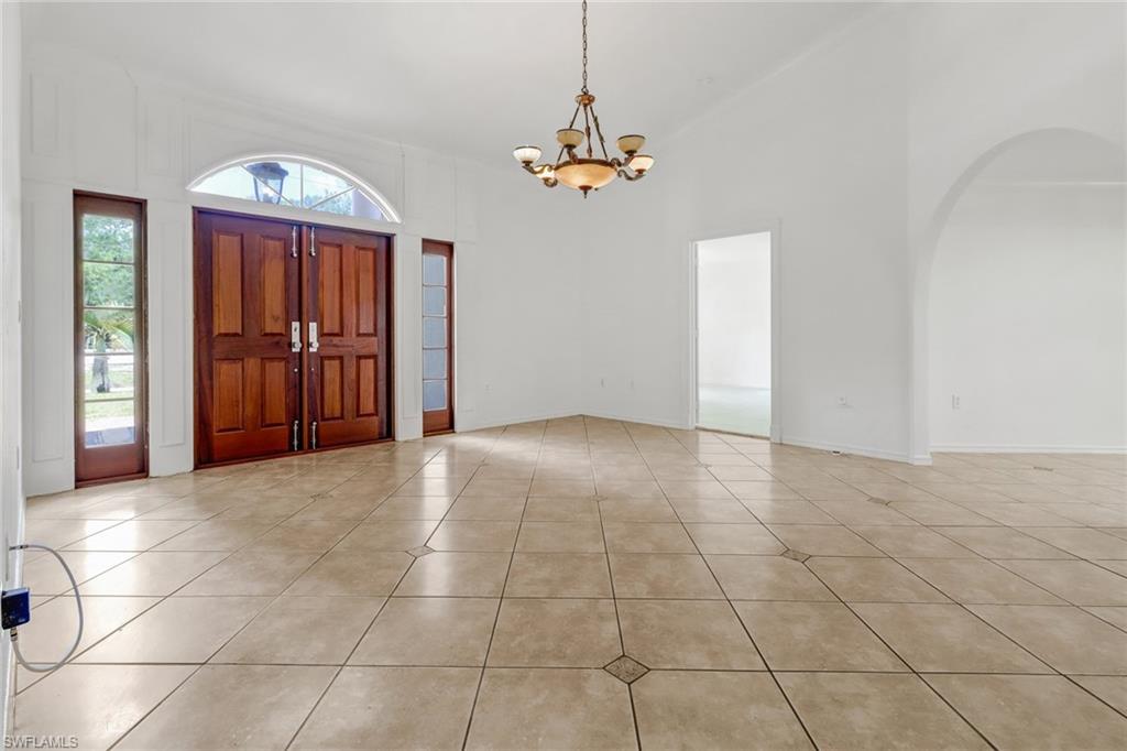 4540 Pine Ridge Road Naples, FL 34119 - Photo 4 of 30 a view of a room with a chandelier fan and windows
