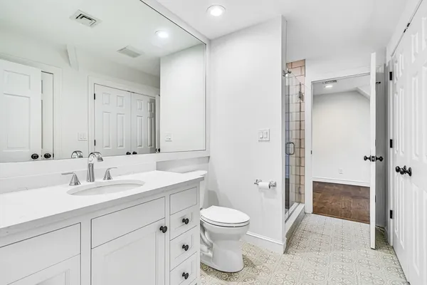 a bathroom with a toilet sink and shower