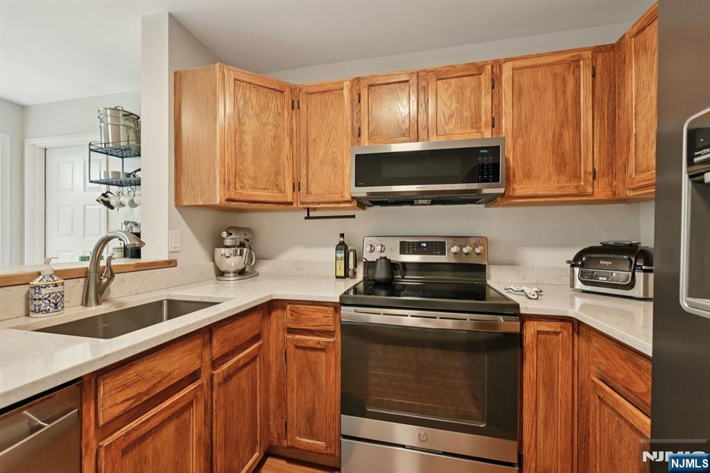 50 Pine Street, Unit 206 Montclair, NJ 07042 - Photo 11 of 23 a kitchen with stainless steel appliances granite countertop a sink stove and microwave