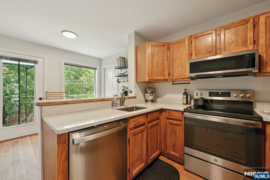 50 Pine Street, Unit 206 Montclair, NJ 07042 - Photo 12 of 23 a kitchen with stainless steel appliances a stove sink microwave and cabinets