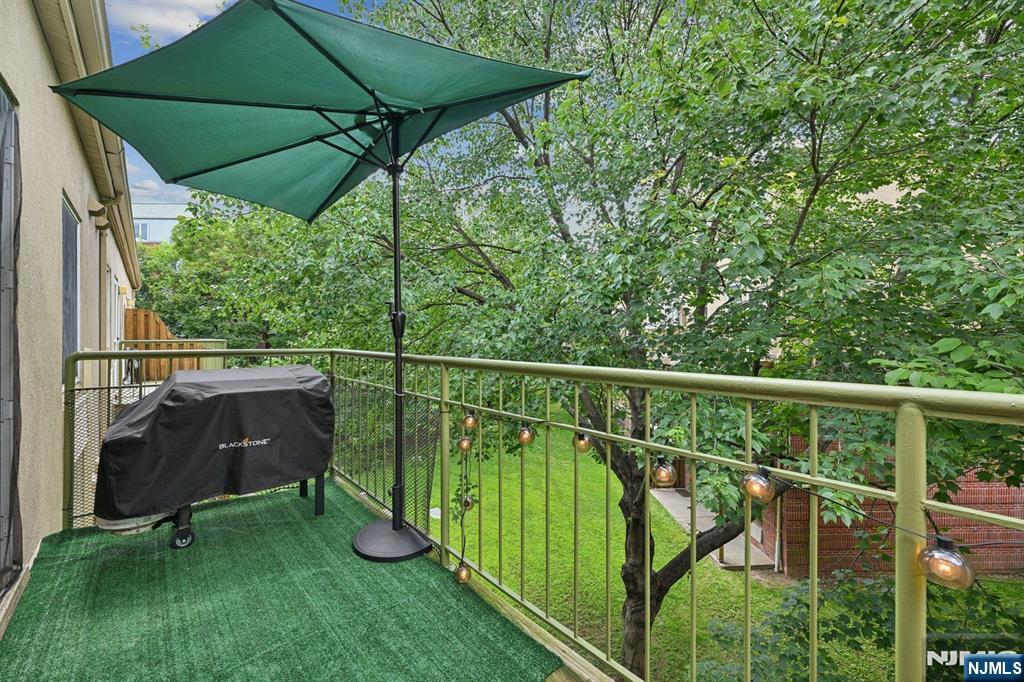 50 Pine Street, Unit 206 Montclair, NJ 07042 - Photo 15 of 23 a view of a chair and table under an umbrella