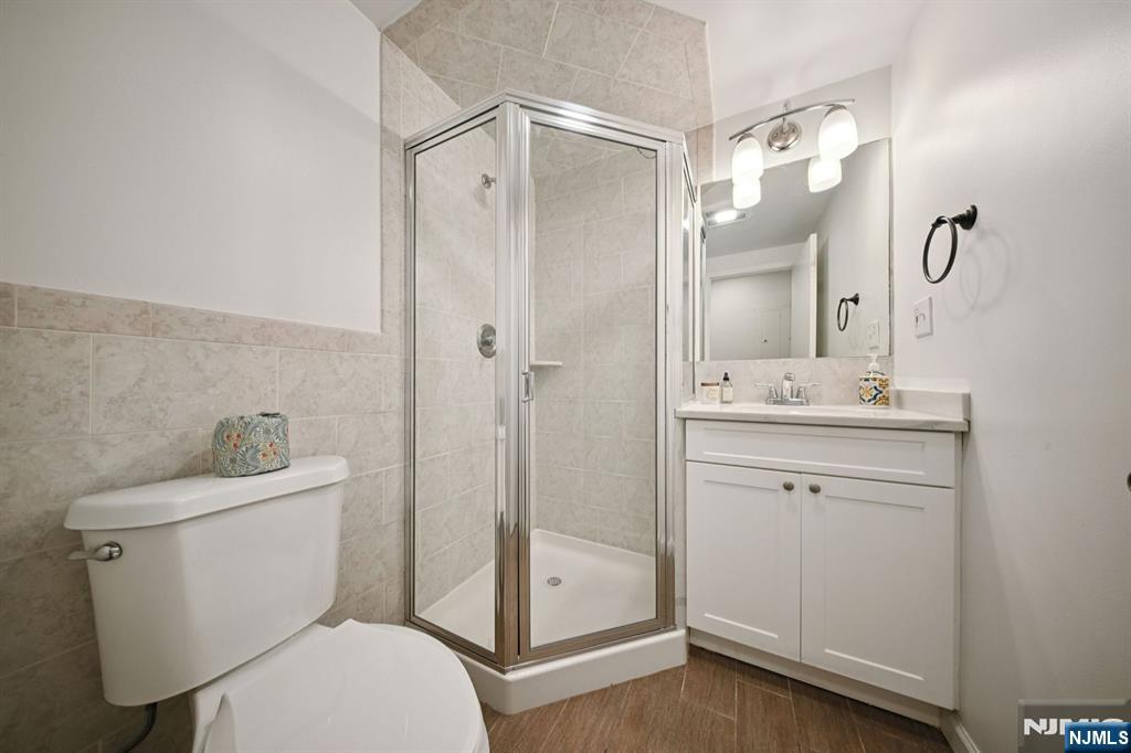 50 Pine Street, Unit 206 Montclair, NJ 07042 - Photo 16 of 23 a bathroom with a toilet a sink and a mirror
