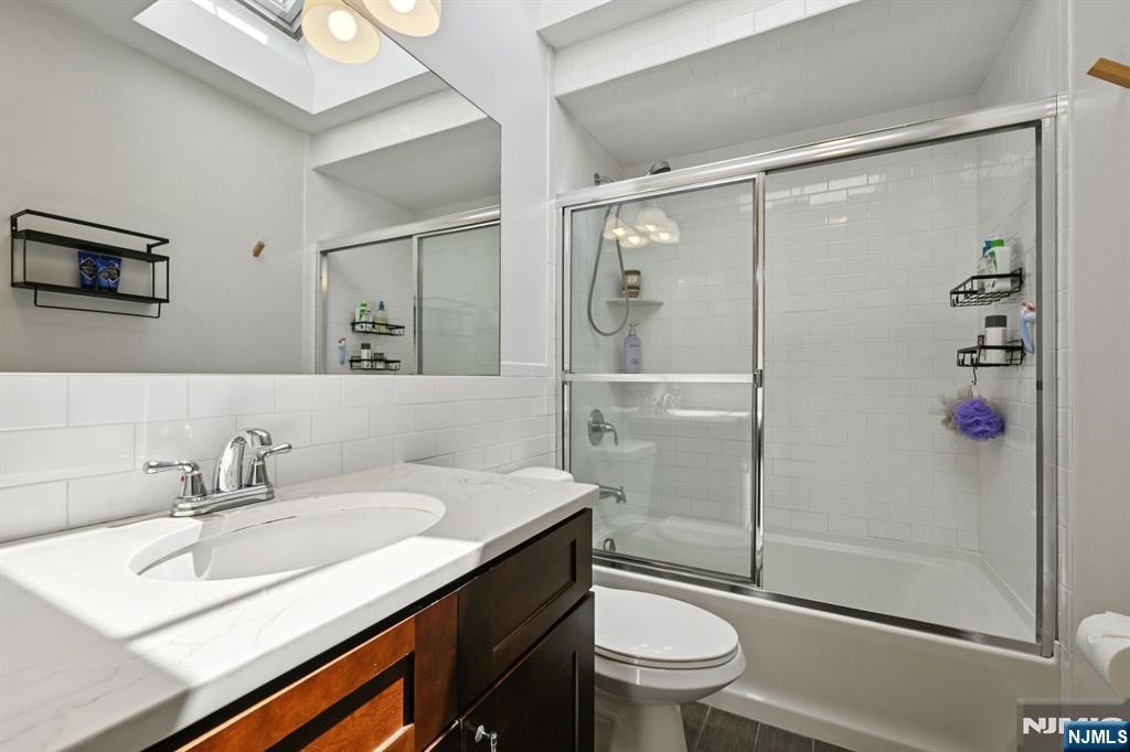 50 Pine Street, Unit 206 Montclair, NJ 07042 - Photo 19 of 23 a bathroom with a sink a toilet and shower