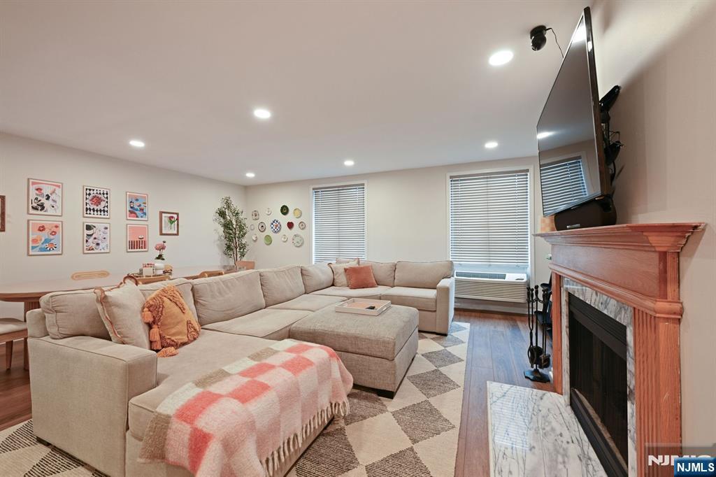 50 Pine Street, Unit 206 Montclair, NJ 07042 - Photo 6 of 23 a living room with furniture a fireplace and a flat screen tv