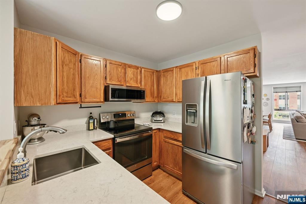 50 Pine Street, Unit 206 Montclair, NJ 07042 - Photo 10 of 23 a kitchen with stainless steel appliances granite countertop a refrigerator stove sink and cabinets
