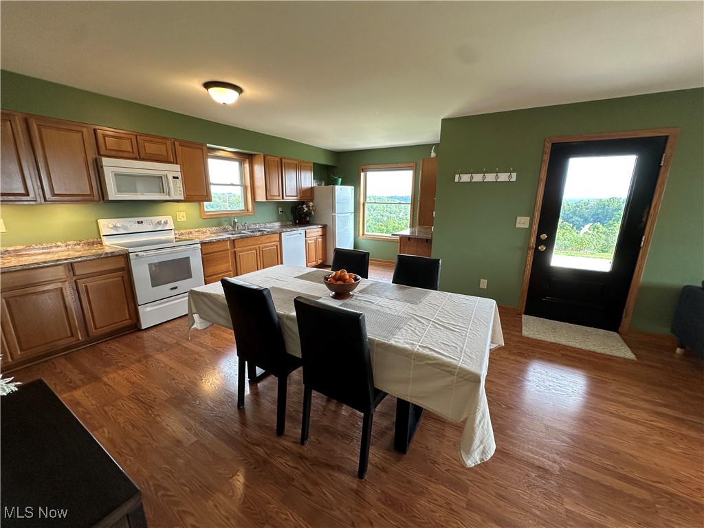 18331 Davis Ridge Road Caldwell, OH 43724 - Photo 6 of 31 Kitchen with white appliances, plenty of natural light, and dark wood-type flooring