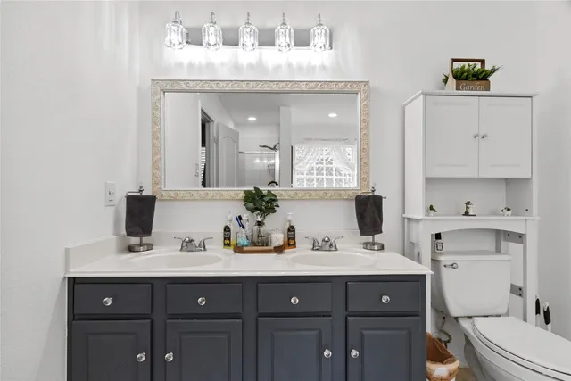 a bathroom with a sink vanity and mirror