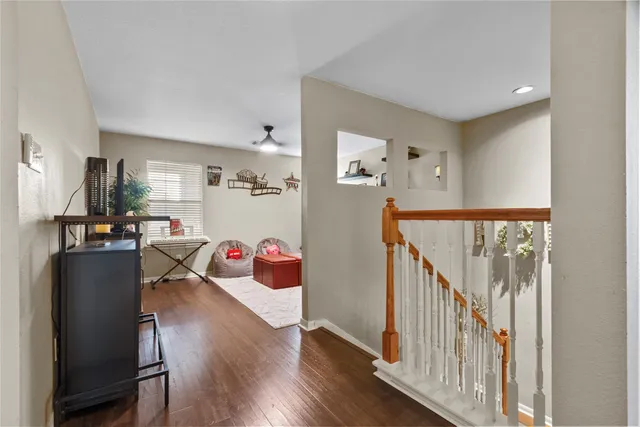a view of a hallway with dining room and wooden floor