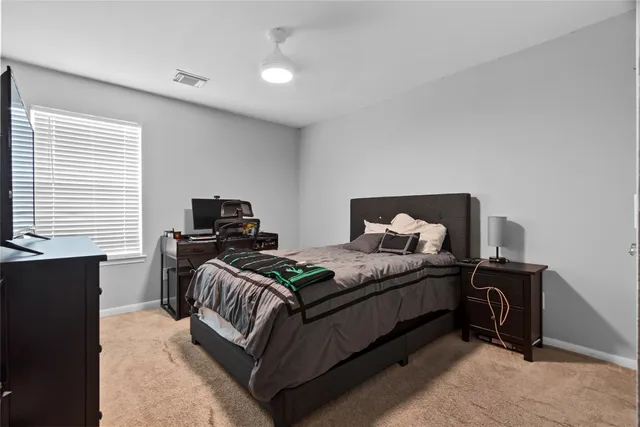 a bedroom with a bed and a window