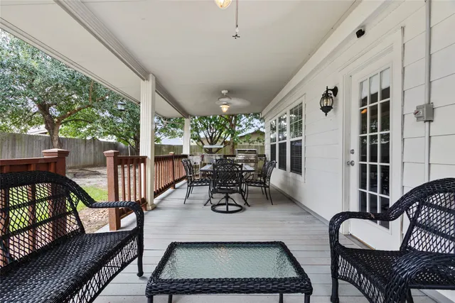 a dining room with furniture water view and a floor to ceiling window