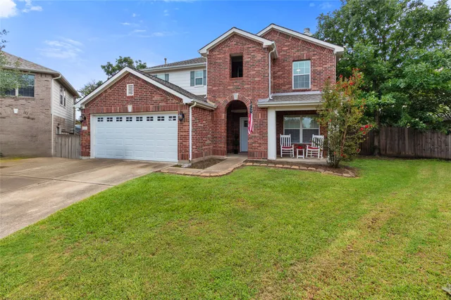 a front view of a house with a yard and garage