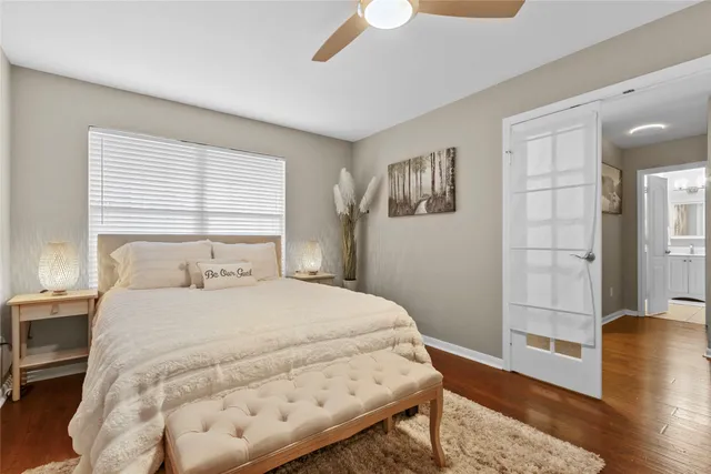 a bedroom with a bed and wooden floor