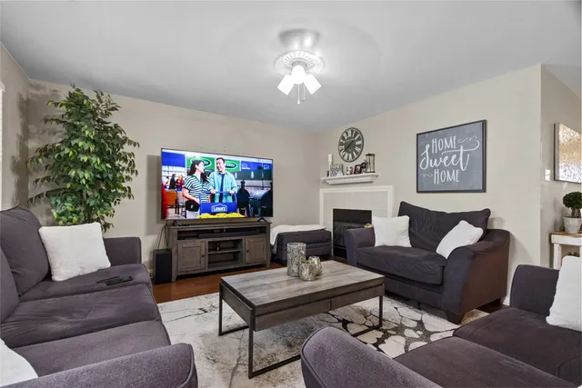a living room with furniture a flat screen tv and a wall