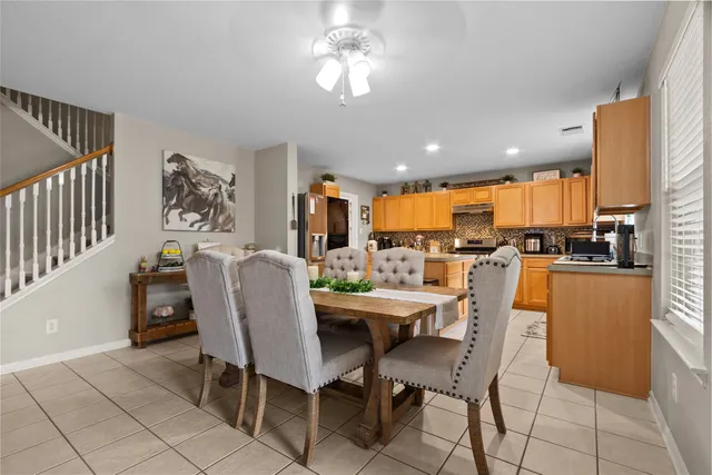 a dining room with furniture and a kitchen view