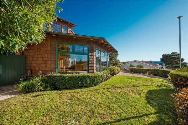 a view of a patio with couches under an umbrella