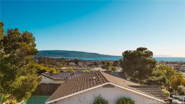 a kitchen with granite countertop a sink a stove and wooden cabinets