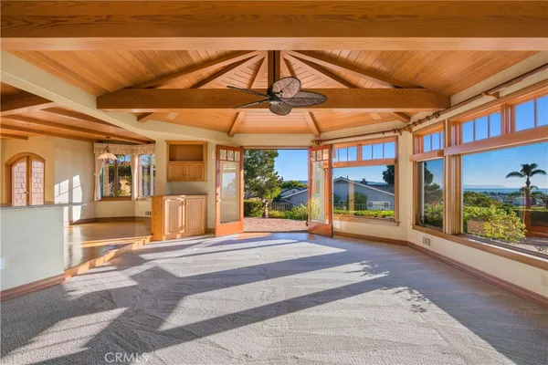 a view of a hallway with wooden floor and a chandelier