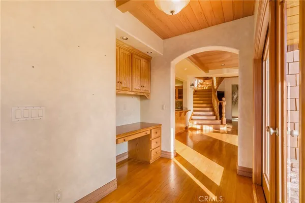 a bedroom with a bed and dresser with mirror