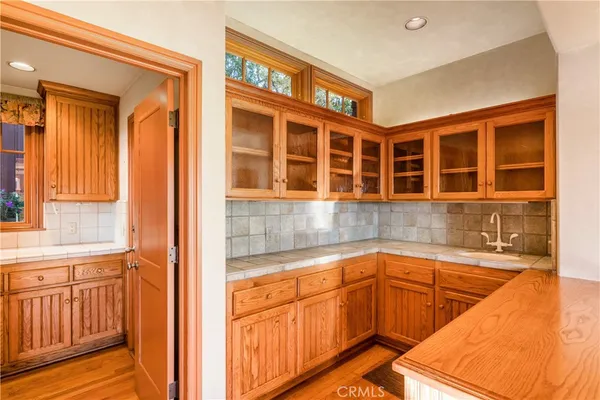 a view of a room with wooden floor and windows