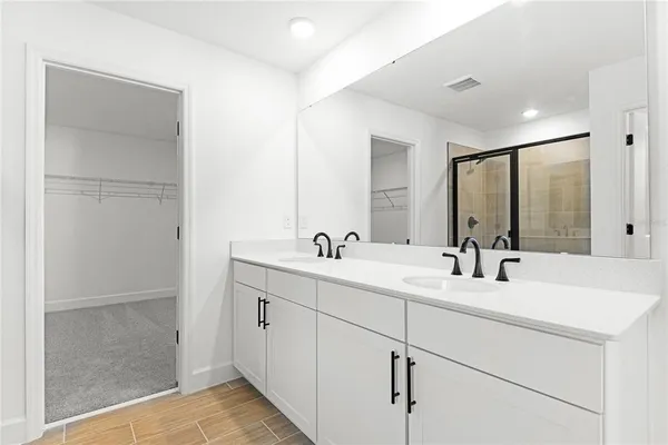 a bathroom with a double vanity sink mirror and double