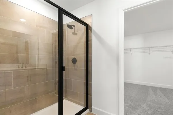 a bathroom with a shower and a glass door