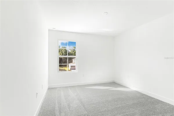 a view of a small space with wooden floor and a window