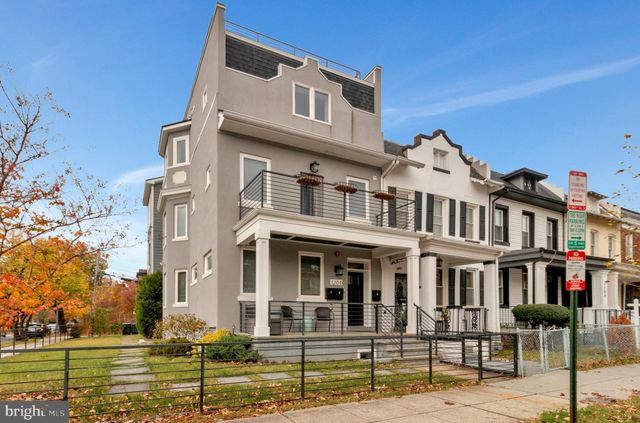 a front view of a residential apartment building with a yard