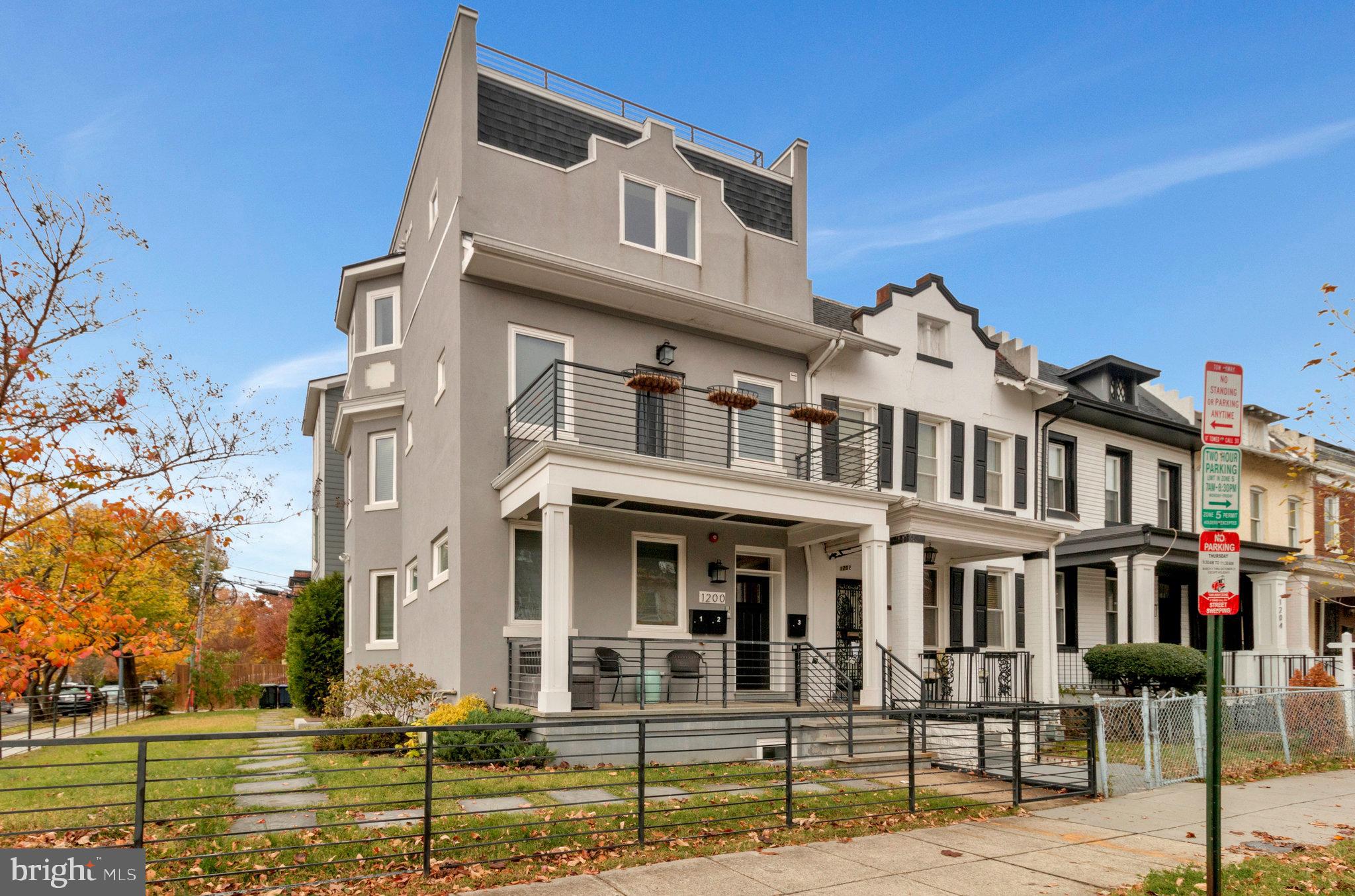 1200 Staples Street Northeast, Unit 1 Washington, DC 20002 - Photo 1 of 37 a front view of a residential apartment building with a yard