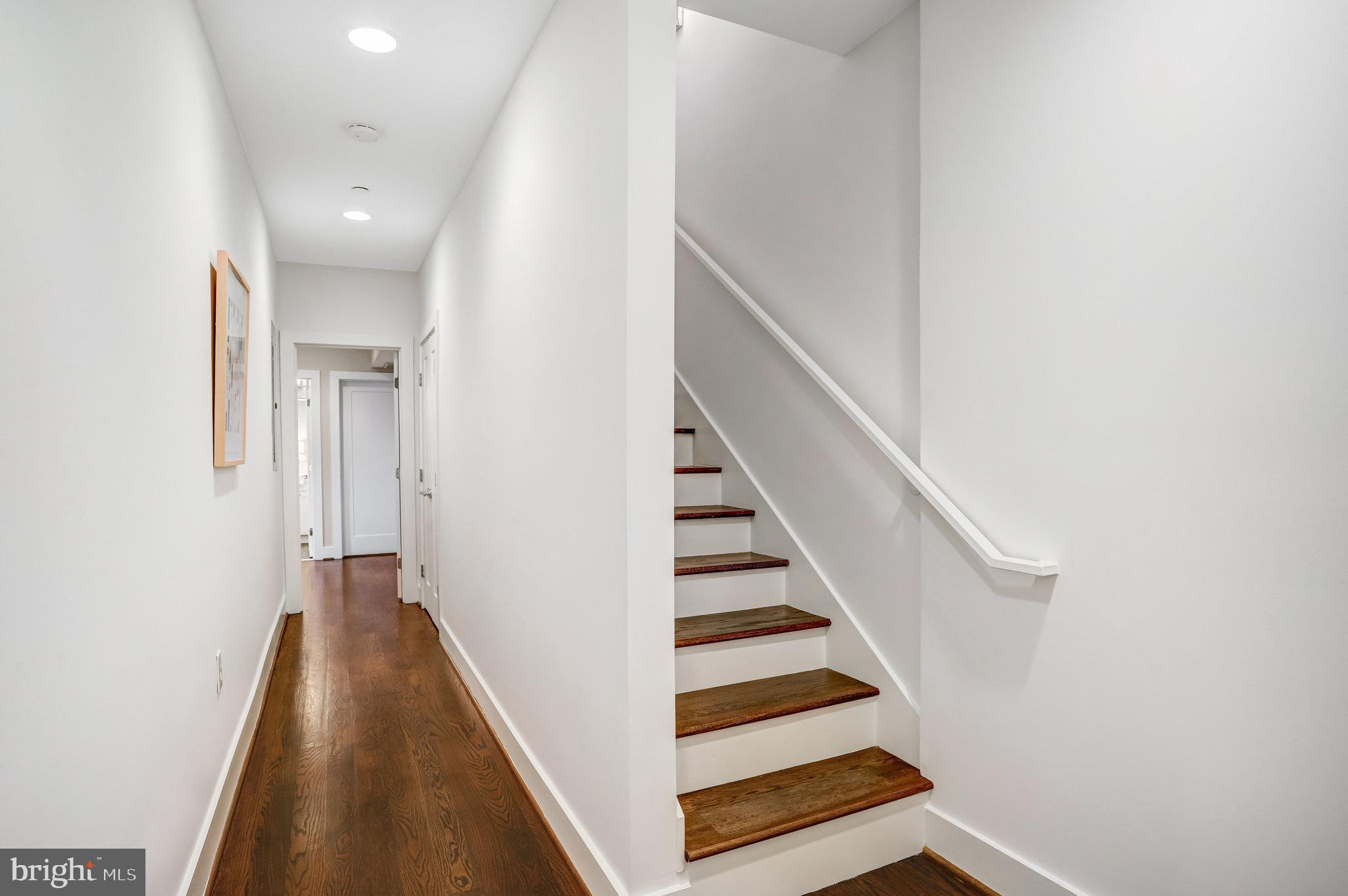 1200 Staples Street Northeast, Unit 1 Washington, DC 20002 - Photo 18 of 37 a view of a hallway with wooden floor and staircase