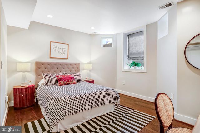 a bedroom with a bed and a lamp