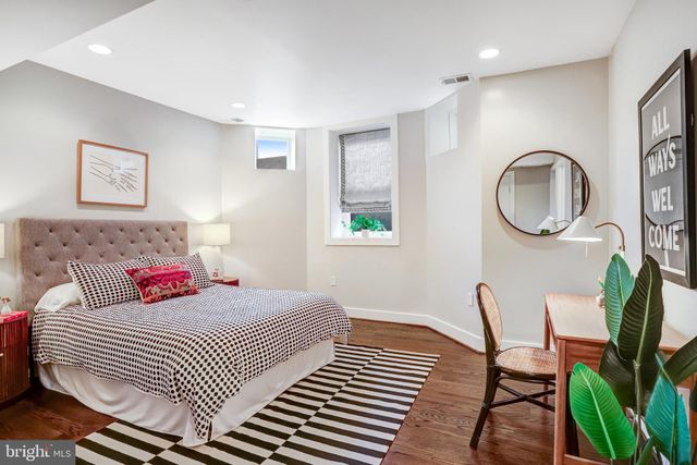 a bedroom with a bed chair and a window