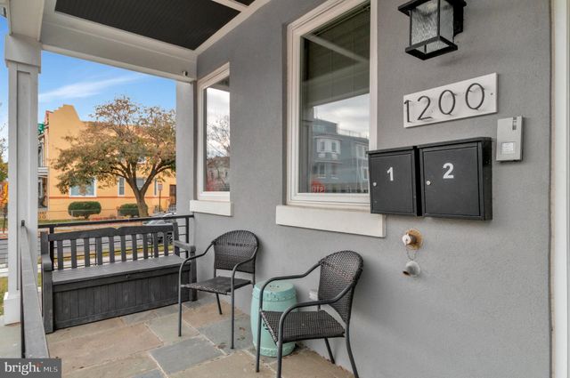 a view of a chairs and table in the balcony