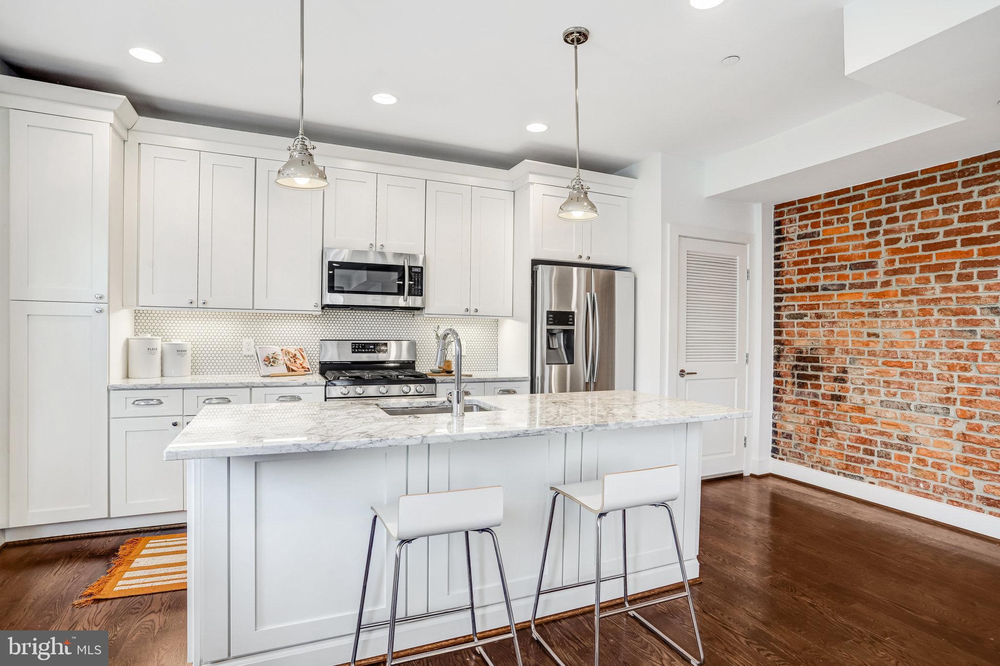 1200 Staples Street Northeast, Unit 1 Washington, DC 20002 - Photo 4 of 37 a kitchen with stainless steel appliances granite countertop a stove refrigerator sink and microwave