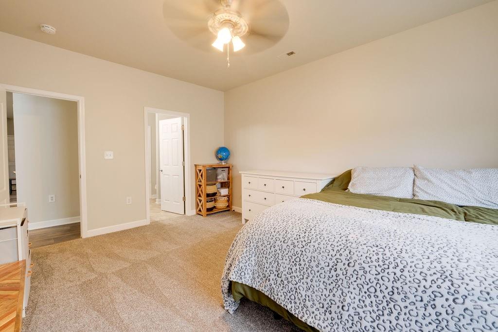 349 Sandy Spring Lane Clover, SC 29710 - Photo 11 of 28 a bedroom with a bed and a chandelier