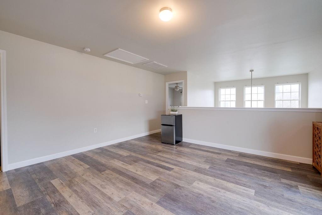 349 Sandy Spring Lane Clover, SC 29710 - Photo 16 of 28 an empty room with wooden floor and windows