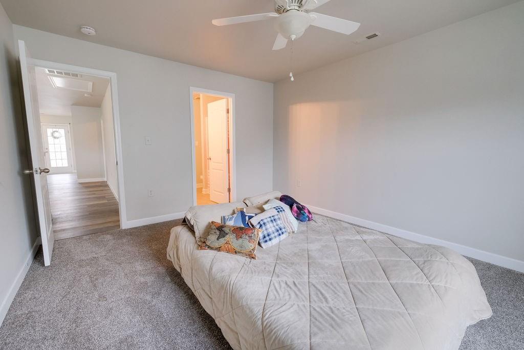 349 Sandy Spring Lane Clover, SC 29710 - Photo 22 of 28 a bed room with a bed and a chandelier