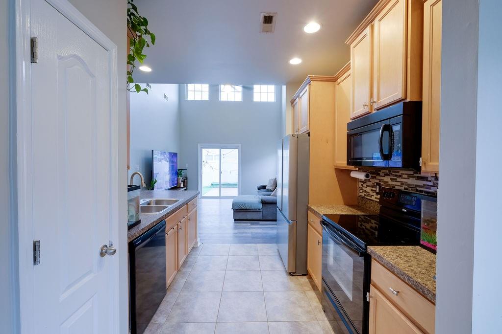 349 Sandy Spring Lane Clover, SC 29710 - Photo 4 of 28 a kitchen with stainless steel appliances granite countertop a stove a sink and a refrigerator