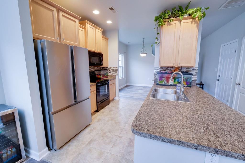 349 Sandy Spring Lane Clover, SC 29710 - Photo 5 of 28 a kitchen with granite countertop a refrigerator and a sink