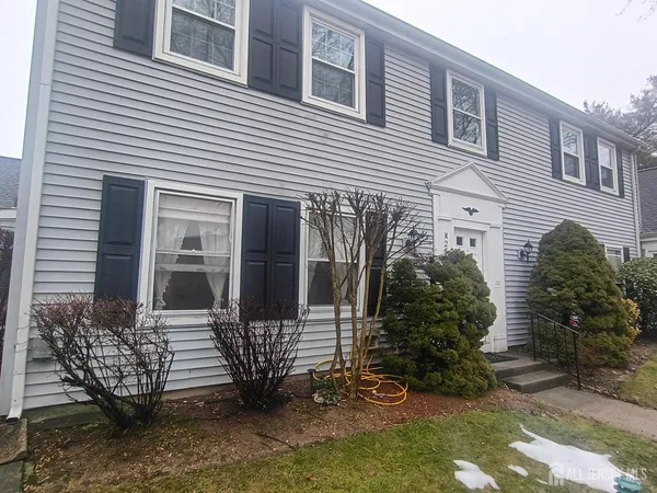 a view of a house with a yard and plants
