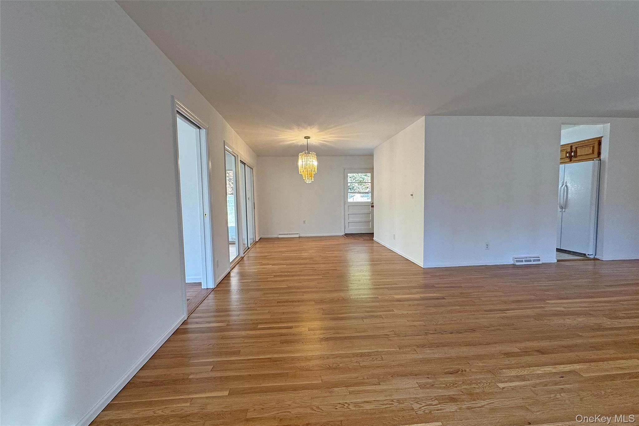 461 Pinebrook Boulevard New Rochelle, NY 10804 - Photo 6 of 32 a view of an empty room with wooden floor