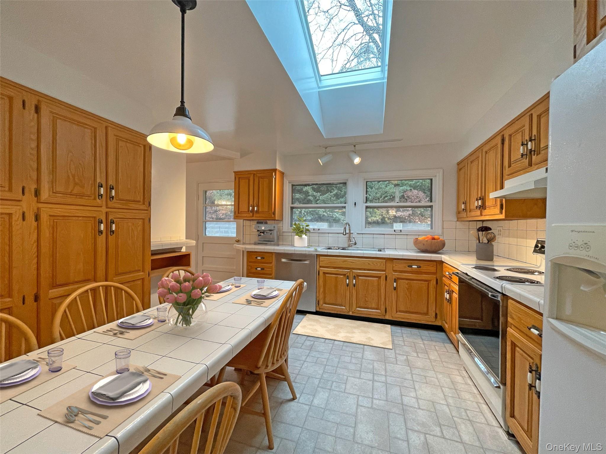 461 Pinebrook Boulevard New Rochelle, NY 10804 - Photo 7 of 32 a kitchen with stainless steel appliances granite countertop a sink a stove a dining table and chairs