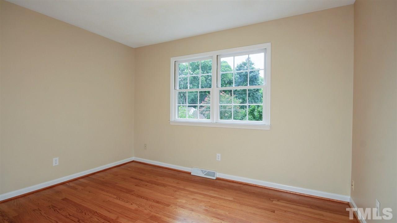 925 Pebblebrook Drive Raleigh, NC 27609 - Photo 11 of 23 a view of an empty room with wooden floor and a window
