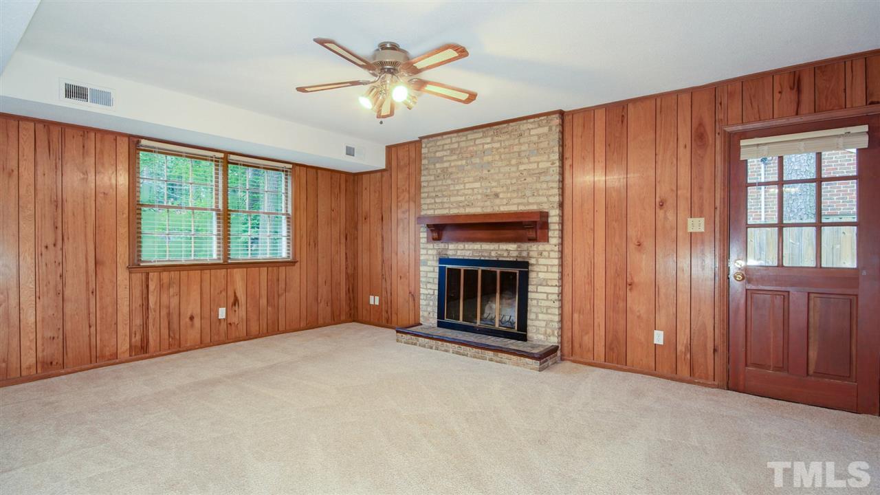 925 Pebblebrook Drive Raleigh, NC 27609 - Photo 12 of 23 an empty room with windows chandelier and fireplace