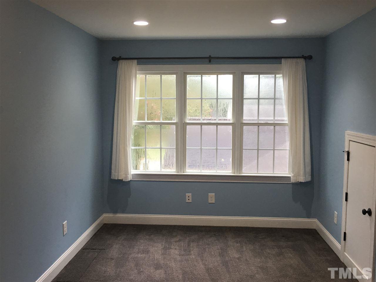 925 Pebblebrook Drive Raleigh, NC 27609 - Photo 17 of 23 an empty room with wooden floor and windows