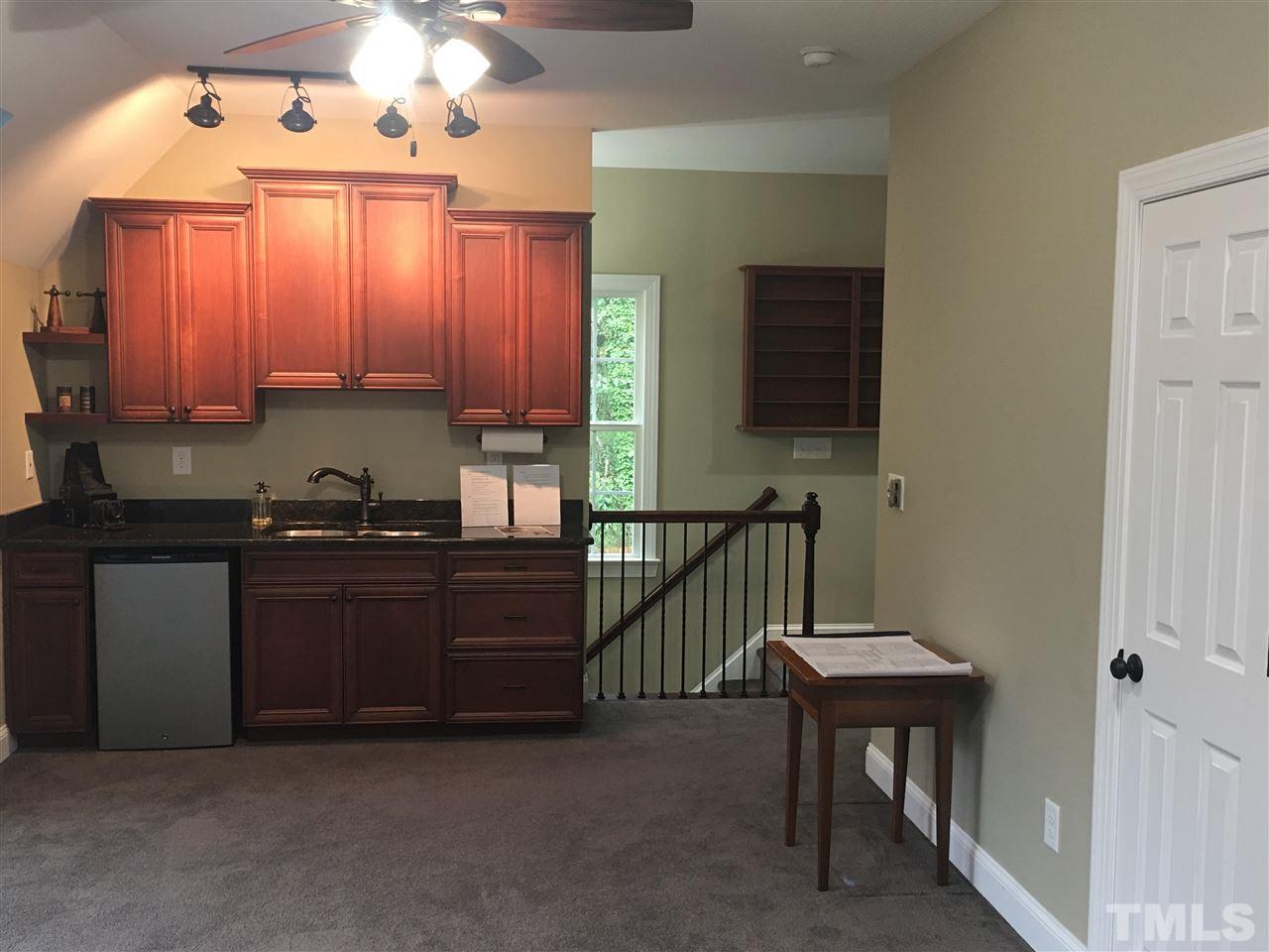 925 Pebblebrook Drive Raleigh, NC 27609 - Photo 18 of 23 a kitchen with granite countertop a stove a sink and a microwave