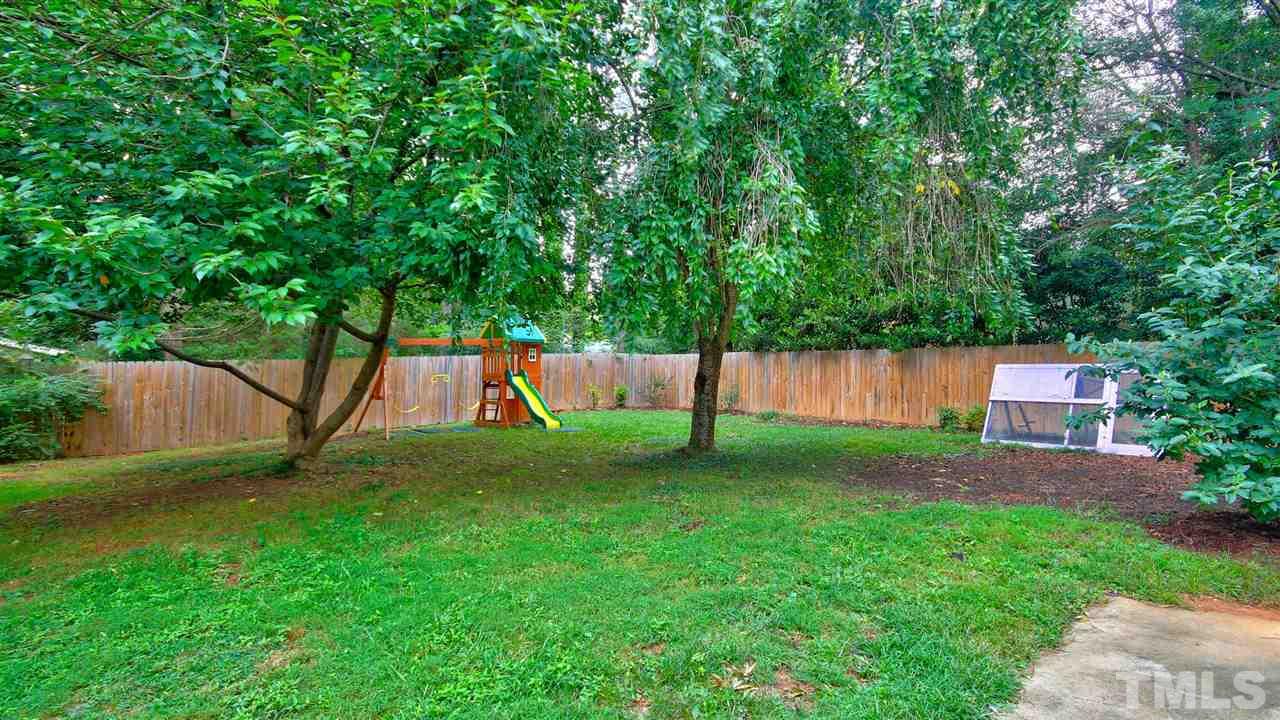 925 Pebblebrook Drive Raleigh, NC 27609 - Photo 21 of 23 a view of backyard with a barn and large trees
