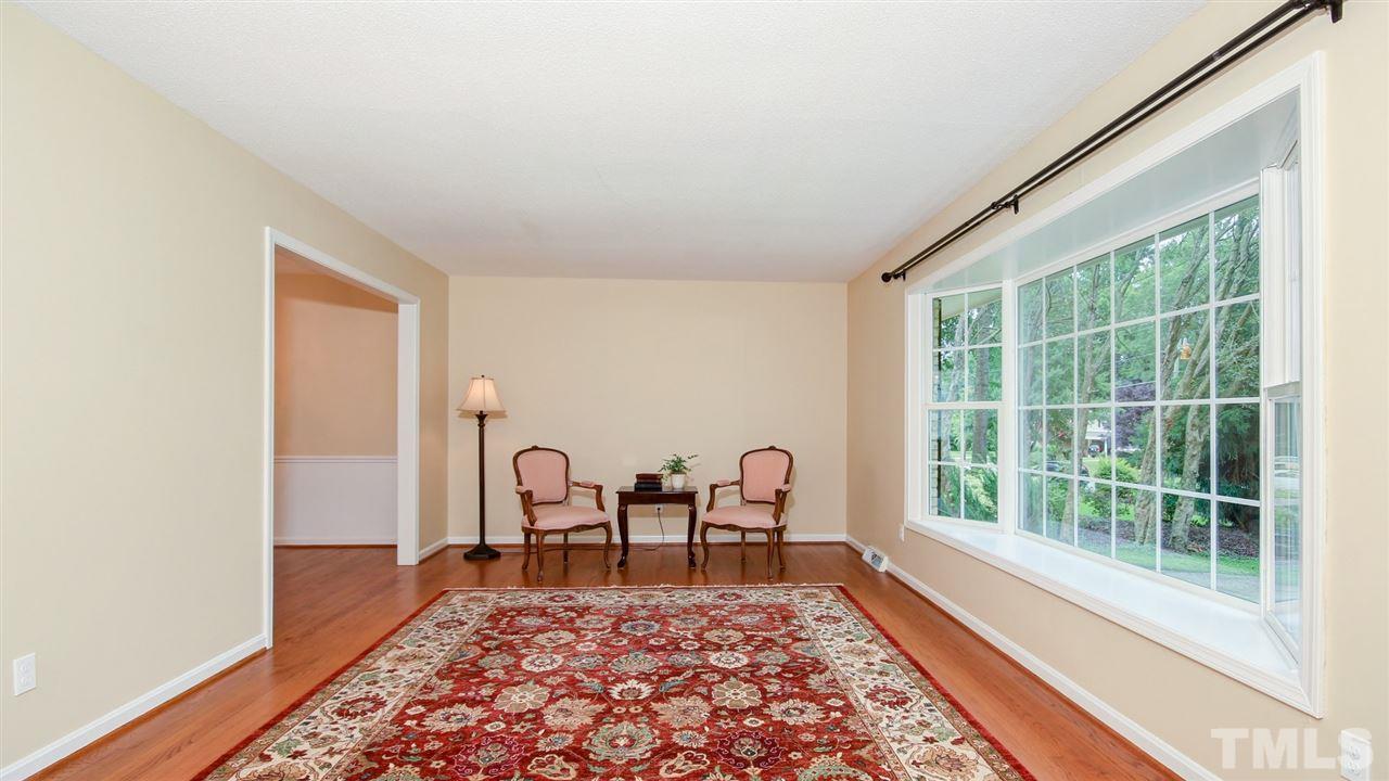 925 Pebblebrook Drive Raleigh, NC 27609 - Photo 4 of 23 a living room with furniture and a rug